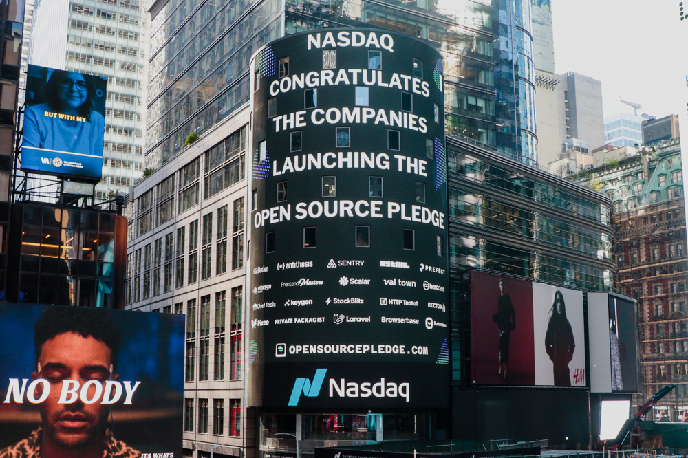 The big Nasdaq screen in Times Square bearing a message saying “Nasdaq congratulates the companies launching the Open Source Pledge”, and some company logos underneath
