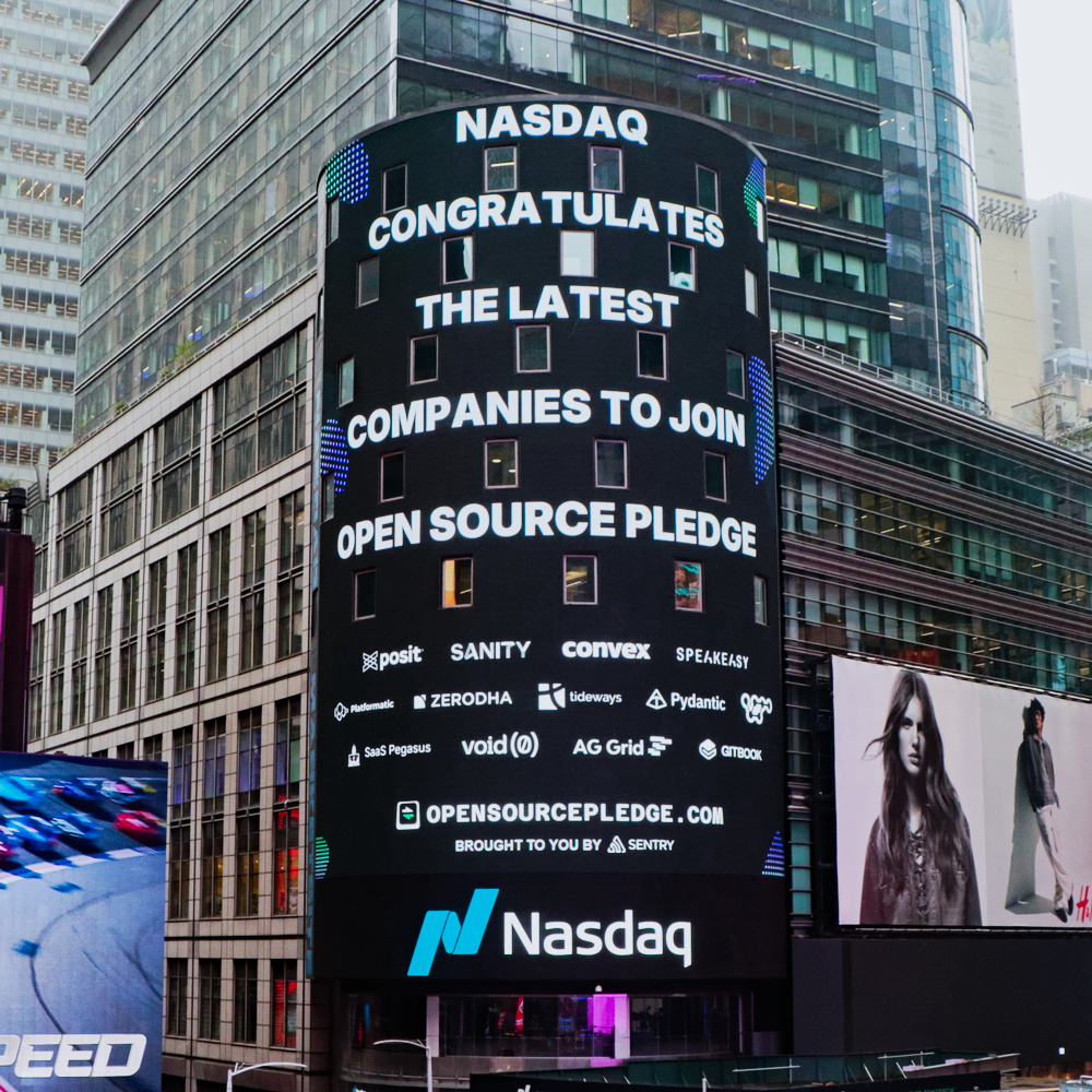 The big Nasdaq screen in Times Square bearing a message saying “Nasdaq congratulates the latest companies to join Open Source Pledge”, and some company logos underneath
