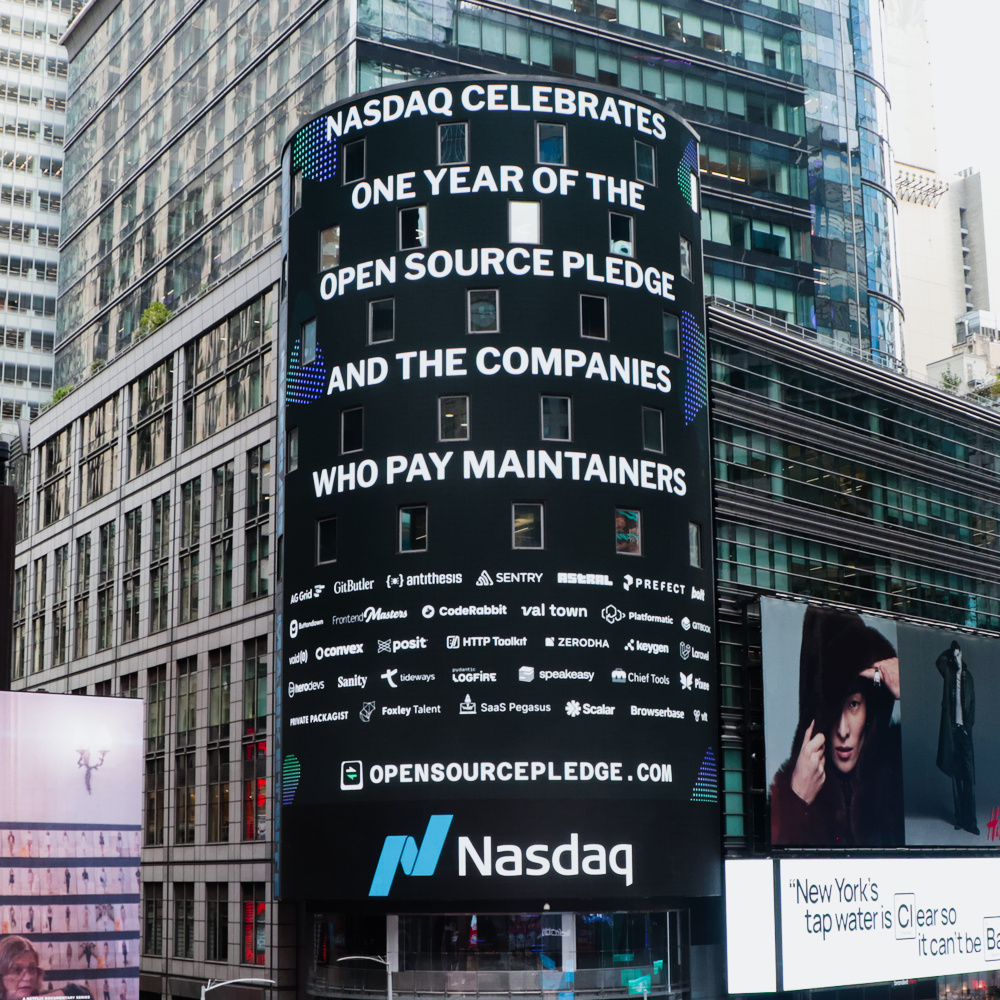 The big Nasdaq screen in Times Square bearing a message saying “Nasdaq celebrates one year of the Open Source Pledge and the companies who pay maintainers”, and many company logos underneath